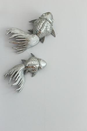 sculpture of metal fish hang on the wallの写真素材