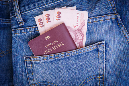 Thailand Passport and money in denim jeans pocketの写真素材