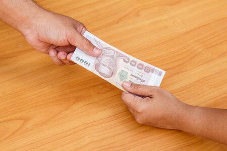 Hand holding moneyの写真素材