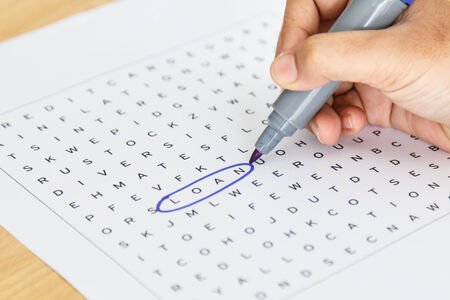 Crossword puzzle close-up Hand doing crossword