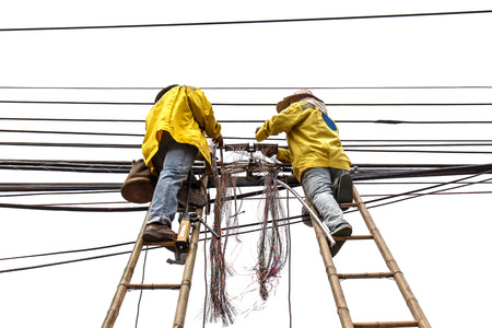 worker on bamboo ladder is repairing telephone lineの写真素材