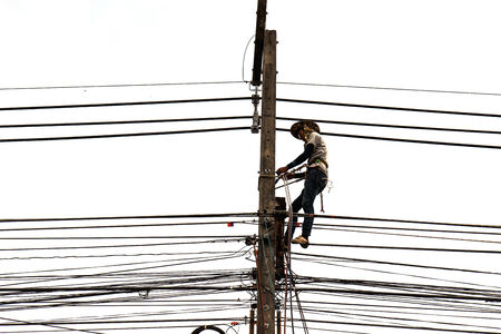 Man working on electric pole isolated on white backgroundの写真素材