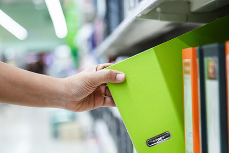 Hand of woman holding folderの写真素材