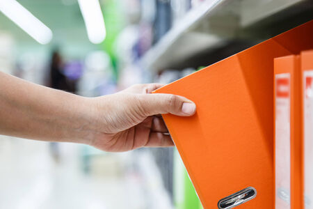 Hand of woman holding folderの写真素材