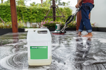Thai people cleaning black granite floor with machine and chemicalの写真素材