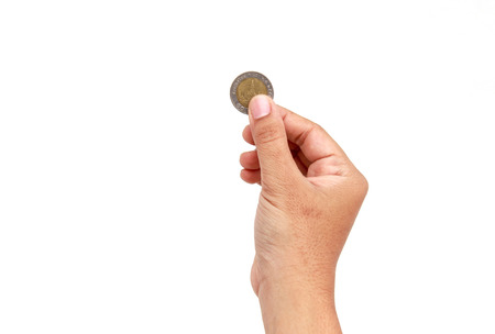 Woman hand holding coin isolates on white backgroundの写真素材