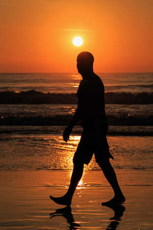 Silhouette of tourist at sunset beach in Phuket Thailandの写真素材