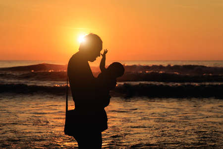 Silhouette of tourist at sunset beach in Phuket Thailandの写真素材
