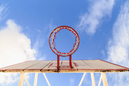 Basketball hoop with cage with blue sky background