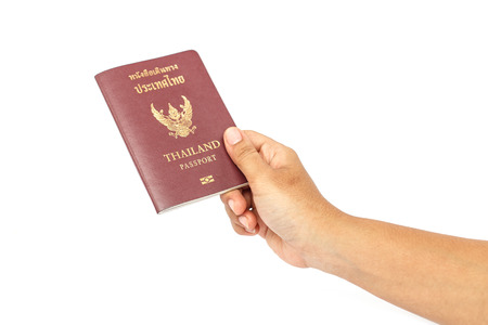 Hand holding Thailand passport isolated on white backgroundの写真素材