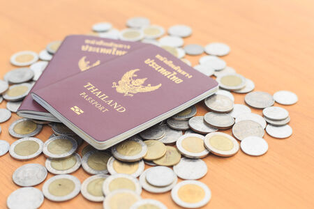 Close up Thailand passport and coin on the table