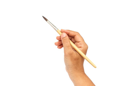 Hand holding paintbrush isolated on white backgroundの写真素材