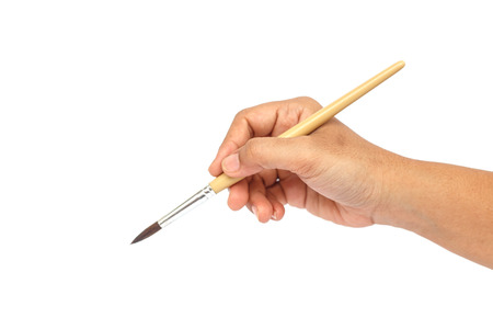 Hand holding paintbrush isolated on white backgroundの写真素材