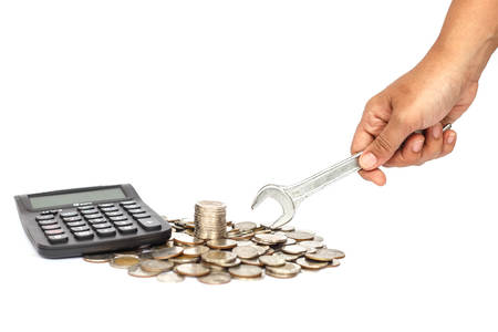 Stack of coin with hand holding wrench in concept repair money problem isolated on white backgroundの写真素材