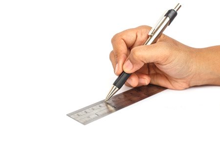 Hand holding pen and ruler isolated on white backgroundの写真素材