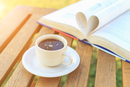 Coffee cup and book on the table in the morningの写真素材