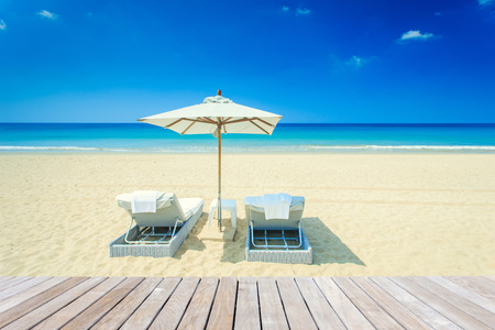 Sun umbrella and sun loungers stand at the beach in Phuket, Thailandの写真素材