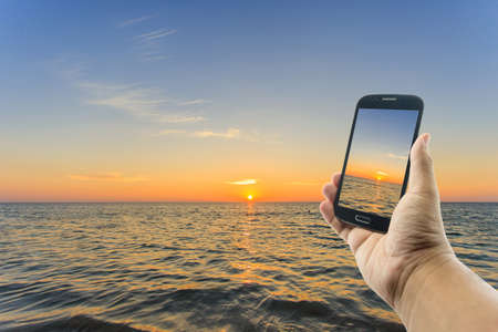 Hand holding smartphoneの写真素材