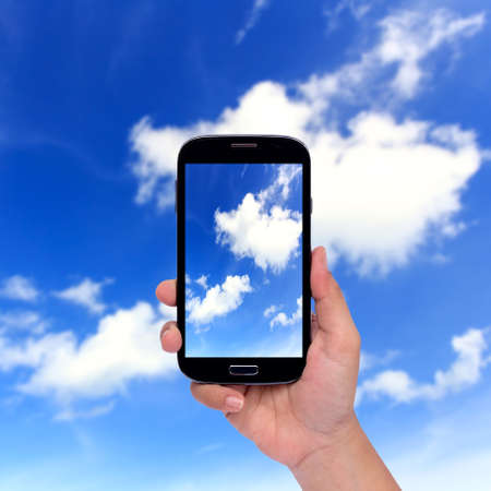 Hand holding smartphone isolated on white backgroundの写真素材