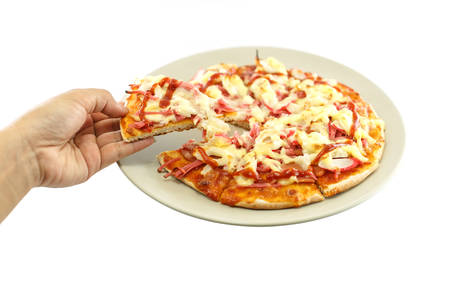 Hand holding piece of pizza isolated on white backgroundの写真素材