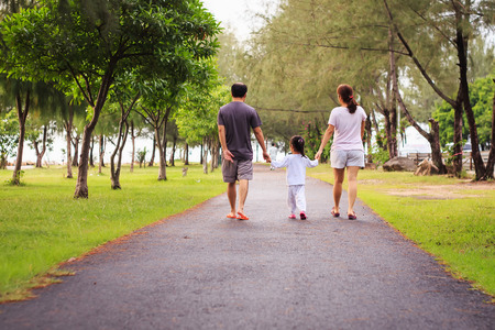 Family walking at park in the morningの写真素材