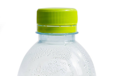 Close up water drop on plastic bottle isolated on white background