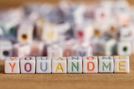 You and me written in letter beads on wood backgroundの写真素材