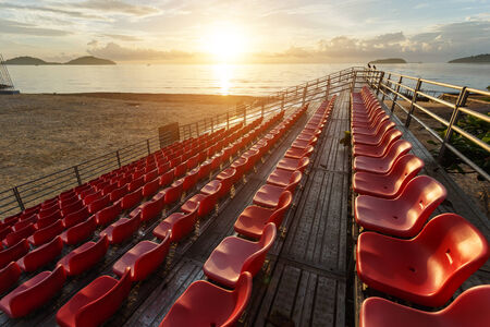 Empty plastic chairs at temporary grandstand stadium in Phuket, Thailandの写真素材