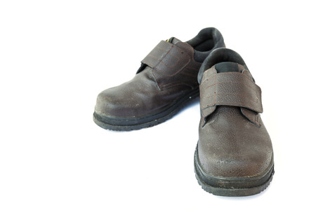 Old safety shoes isolated on white backgroundの写真素材