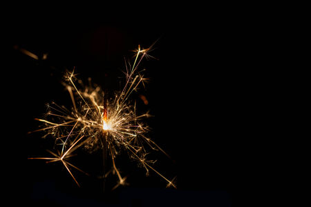 Christmas sparkler on black backgroundの写真素材