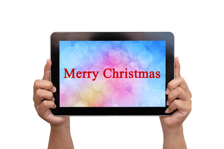 Hand holding tablet with text merry christmasの写真素材