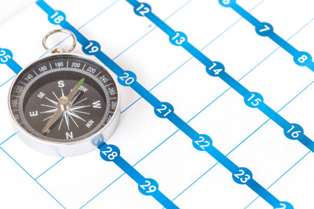 Close up Compass on calendarの写真素材