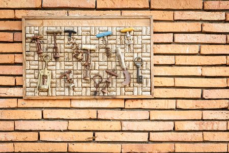 HUAHIN, THAILAND - DECEMBER 27, 2014 â A collection of dozen vintage corkscrews hang on the brick wall in shop in wine shop on Dec 27, 2014 at huahin province, prachuap khiri khan, thailandのeditorial素材