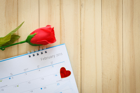 Close up Rose and calendar on wooden floorの写真素材