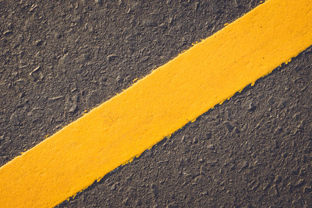 Asphalt road texture with yellow stripeの写真素材