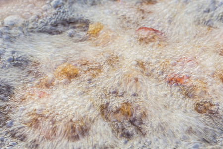 Blur of hot and boiling food oil in pan while fried chicken