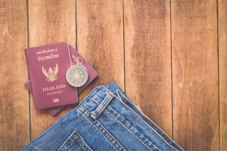 Close up Thailand passport and compass on woodの写真素材