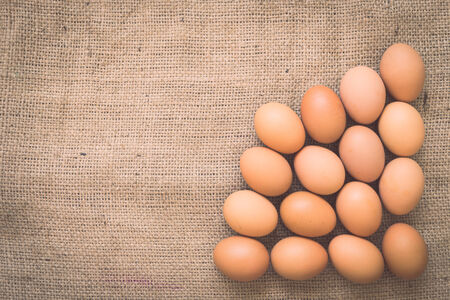Eggs on old crumpled burlap, Backgroundの写真素材