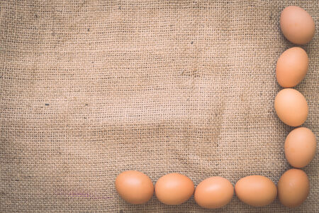 Eggs on old crumpled burlap, Backgroundの写真素材