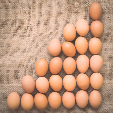 Eggs on old crumpled burlap, Backgroundの写真素材