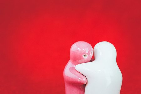 Two ceramic doll on red fabric, With retro filter effectの写真素材