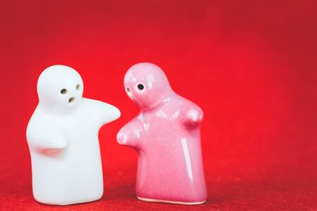 Two ceramic doll on red fabric, With retro filter effectの写真素材