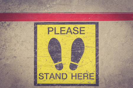 PLEASE STAND HERE foot sign or symbol on the floor, Retro filter effectの写真素材