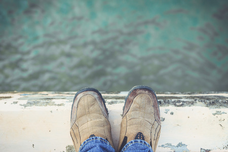 Feet Standing on Cement Edge Near The Sea
