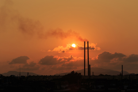 Silhouette of Smokestacks at sunset time in Phuket, Thailandの写真素材
