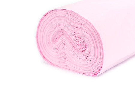 Roll of pink garbage bag isolated on white backgroundの写真素材