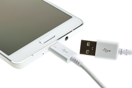 Macro Smartphone connect with charger isolated on white 