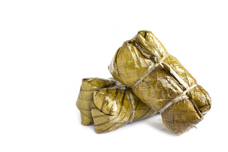 Traditional Thai dessert, Steamed sticky rice with banana and black beans Wrapped in a banana leafの写真素材