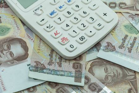 Close up Thai money in one thousand type banknotes with calculator
