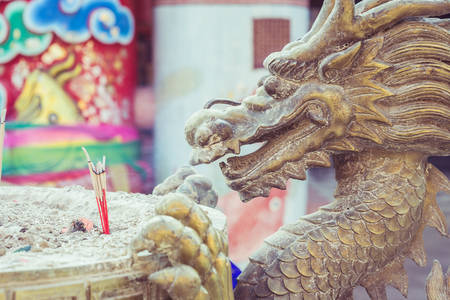 Close up steel dragon statue on incense bucket in Chinese templeの写真素材
